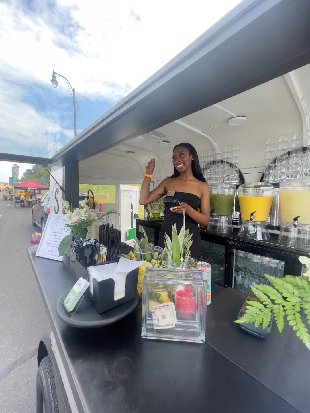 Picture of lady serving drinks from mobile bar.